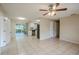 Living room with tile floors and access to the kitchen and patio at 5511 Indian Hill Rd, Orlando, FL 32808
