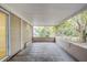 Spacious screened porch with tile flooring and backyard access at 5511 Indian Hill Rd, Orlando, FL 32808