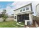 A view of the home's backyard and screened-in porch with well maintained grassy area and fence at 618 Windy Pine Way, Oviedo, FL 32765