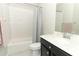 Bright bathroom features a shower-tub combination, vanity with marble countertop, and modern fixtures at 618 Windy Pine Way, Oviedo, FL 32765