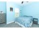 A serene, blue-themed bedroom features a bed, dresser, nightstand, and window for a calm and restful space at 618 Windy Pine Way, Oviedo, FL 32765