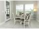 Cozy dining area with a round table, seating for four, and bright natural light at 618 Windy Pine Way, Oviedo, FL 32765
