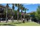 Exterior shot of a dog park surrounded by palm trees, new buildings, and lush greenery at 618 Windy Pine Way, Oviedo, FL 32765
