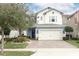 Charming two-story home featuring a 2-car garage and a beautifully landscaped front yard and brick driveway at 618 Windy Pine Way, Oviedo, FL 32765
