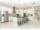 Spacious kitchen with white cabinetry, granite countertops, stainless steel appliances, and a large center island at 618 Windy Pine Way, Oviedo, FL 32765