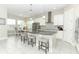 Bright kitchen with stainless steel appliances, granite countertops, island seating, and an adjacent dining area at 618 Windy Pine Way, Oviedo, FL 32765