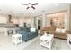 Inviting living room with two sofas, a gray rug and access to kitchen and dining areas at 618 Windy Pine Way, Oviedo, FL 32765