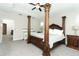 Spacious main bedroom featuring a decorative canopy bed and neutral carpet flooring at 618 Windy Pine Way, Oviedo, FL 32765