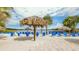 Beach area with tiki huts and lounge chairs at 702 Rum Run # 38702, Davenport, FL 33897