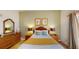 Comfortable bedroom with a queen bed and wicker furniture at 702 Rum Run # 38702, Davenport, FL 33897