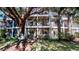 Building exterior with balconies and large tree at 702 Rum Run # 38702, Davenport, FL 33897