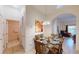 Condo dining area with glass table and view of living room at 702 Rum Run # 38702, Davenport, FL 33897