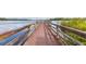 Wooden dock extending over calm lake water at 702 Rum Run # 38702, Davenport, FL 33897