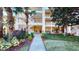 Inviting condo building with lush landscaping and walkway at 702 Rum Run # 38702, Davenport, FL 33897