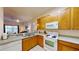 Well-equipped kitchen with wood cabinets and appliances at 702 Rum Run # 38702, Davenport, FL 33897