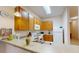 Kitchen with wood cabinets and a breakfast bar at 702 Rum Run # 38702, Davenport, FL 33897