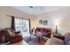 Living room with comfortable seating, a coffee table, and sliding glass doors to a patio at 702 Rum Run # 38702, Davenport, FL 33897