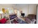 Bright living room with comfy couches, a coffee table, and a view of the kitchen at 702 Rum Run # 38702, Davenport, FL 33897