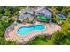 Community pool with surrounding lounge chairs and clubhouse at 702 Rum Run # 38702, Davenport, FL 33897