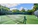 Well-maintained tennis court with net and surrounding fence at 702 Rum Run # 38702, Davenport, FL 33897
