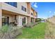 Backyard with grassy lawn and modern townhomes at 7575 Brooklyn Dr, Kissimmee, FL 34747