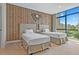 Twin bedroom with wood accent wall and large window with a view at 7575 Brooklyn Dr, Kissimmee, FL 34747