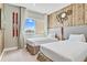Twin bedroom with rustic wood accent wall and large window at 7575 Brooklyn Dr, Kissimmee, FL 34747