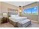Bedroom with king-size bed, ottoman, and large window with a view at 7575 Brooklyn Dr, Kissimmee, FL 34747