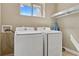 Laundry room with washer, dryer, and shelving at 7575 Brooklyn Dr, Kissimmee, FL 34747