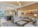 Open floor plan with L-shaped sectional and kitchen at 7575 Brooklyn Dr, Kissimmee, FL 34747