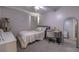 Bright bedroom with a double bed, desk, and mirror at 7749 Brookway St, Orlando, FL 32817