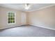 Spacious bedroom with carpeted floors and large window at 814 Crest Pines Dr # 937, Orlando, FL 32828