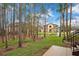 View of the apartment complex from a wooded area with a pond at 814 Crest Pines Dr # 937, Orlando, FL 32828