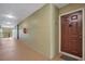Apartment hallway with a brown door and fire extinguisher at 814 Crest Pines Dr # 937, Orlando, FL 32828