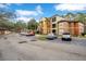 Parking lot view of the apartment complex with cars parked at 814 Crest Pines Dr # 937, Orlando, FL 32828