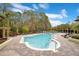 Relaxing kidney-shaped community pool with surrounding lounge chairs at 814 Crest Pines Dr # 937, Orlando, FL 32828