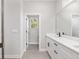 Bathroom with double vanity, gray tile flooring, and a separate toilet area at 8549 Sw 129Th Ln, Ocala, FL 34473