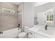 Modern bathroom with white vanity and bathtub at 8549 Sw 129Th Ln, Ocala, FL 34473