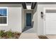 Modern front door with gray color and sleek hardware at 8549 Sw 129Th Ln, Ocala, FL 34473