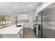 Modern kitchen with white cabinets, quartz countertops, and stainless steel appliances at 8549 Sw 129Th Ln, Ocala, FL 34473