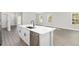 Modern kitchen island with white cabinets, quartz countertop, and stainless steel dishwasher at 8549 Sw 129Th Ln, Ocala, FL 34473