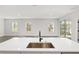 Modern kitchen island with a copper sink and black faucet at 8549 Sw 129Th Ln, Ocala, FL 34473