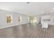 Open concept living room with hardwood floors and sliding glass doors at 8549 Sw 129Th Ln, Ocala, FL 34473
