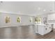 Open living room with hardwood floors and access to kitchen at 8549 Sw 129Th Ln, Ocala, FL 34473