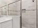 Modern shower with gray tile and glass enclosure at 8549 Sw 129Th Ln, Ocala, FL 34473