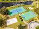 Community park offers tennis, basketball, sand volleyball courts, and a playground near a lake at 943 Oak Chase Dr, Orlando, FL 32828