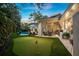 Outdoor entertaining area with pool, putting green, and covered patio at 1000 Via Tuscany Oaks Way, Winter Park, FL 32789