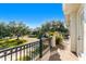 Private balcony overlooking a tree-lined street and neighborhood at 1000 Via Tuscany Oaks Way, Winter Park, FL 32789