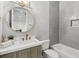 Clean bathroom with gray tile, a white bathtub, and a modern vanity at 1000 Via Tuscany Oaks Way, Winter Park, FL 32789