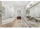 Elegant bathroom with double vanity, soaking tub, and separate shower at 1000 Via Tuscany Oaks Way, Winter Park, FL 32789